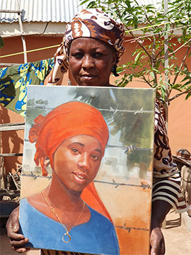 Rebecca Sharibu with a painting of Leah